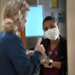 Danielle Gonzalez, right, talks with Michelle Lucas, senior nurse practitioner in the cardiology department at the University of Maryland St.  Joseph Medical Center.  Gonzalez is a graduate of CCBC and participates in the Health Promotion Program, which provides a group of CCBC nursing students with guaranteed education and work at the University of Maryland St.  Joseph Medical Center after graduation.  (Lloyd Fox/Staff)